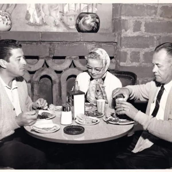 Three people enjoying Mexican food at a table in La Luz del Día Restaurant.
