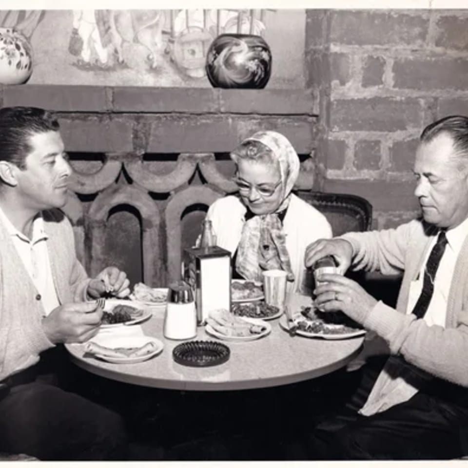Three people enjoying Mexican food at a table in La Luz del Día Restaurant.